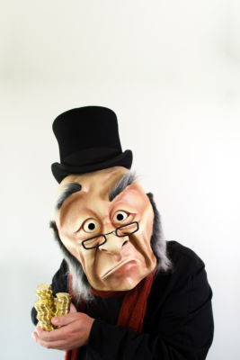 Photo by Kate Braidwood • Dimensions: 3338 x 5007px • File Type: JPG • File Size: 1MB Ebeneezer Scrooge clutches a stack of gold coins. From 'A WONDERHEADS Christmas Carol' by WONDERHEADS, a physical theatre company specializing in full-face mask performance.